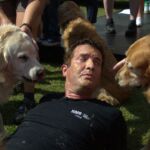 Rick Mercer with peanut butter on face surrounded by goldens